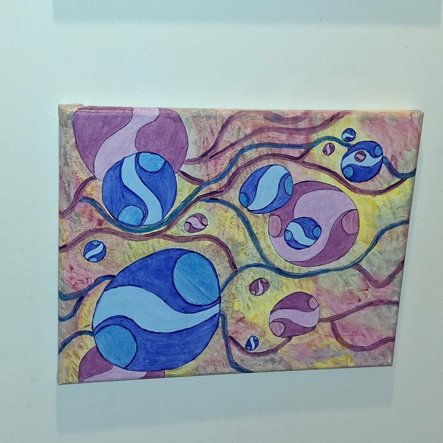 Abstract artwork with blue and purple circular shapes on a colorful background