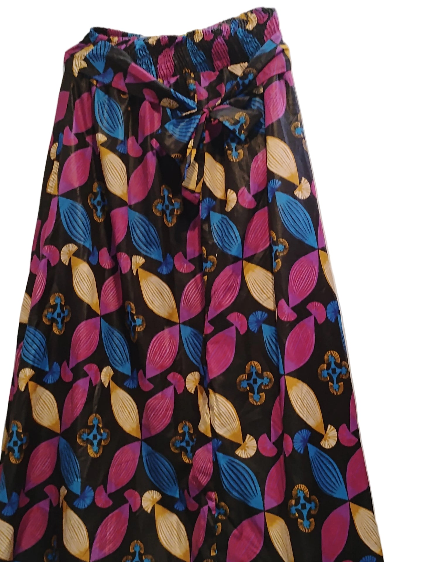 Folded fabric with colorful leaf pattern on a white surface