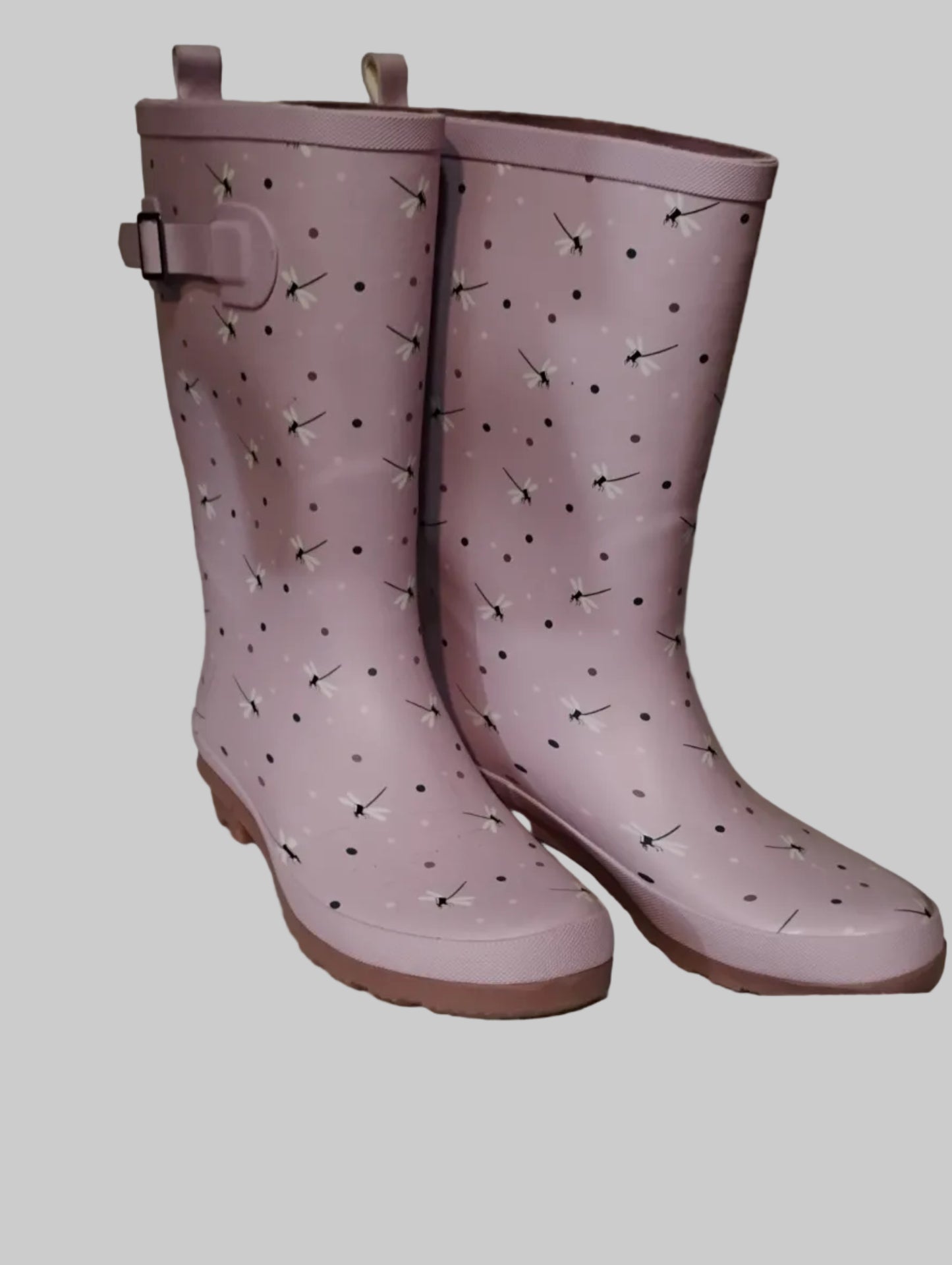Pair of pink rain boots with a pattern on a light gray background