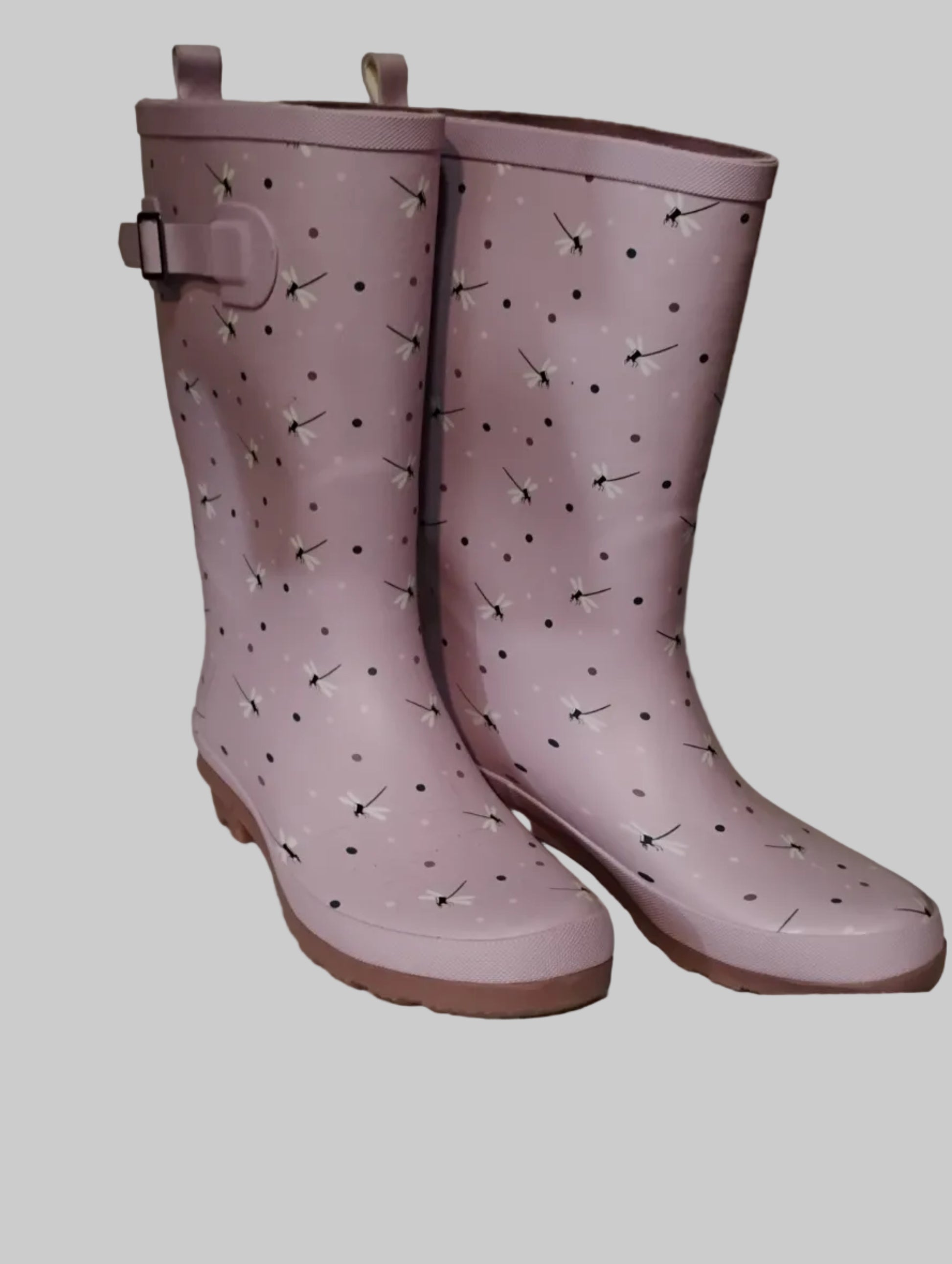 Pair of pink rain boots with a pattern on a light gray background